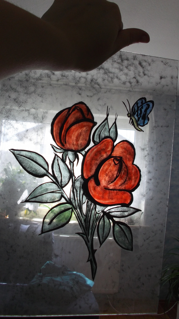 Rose and butterfly on glas