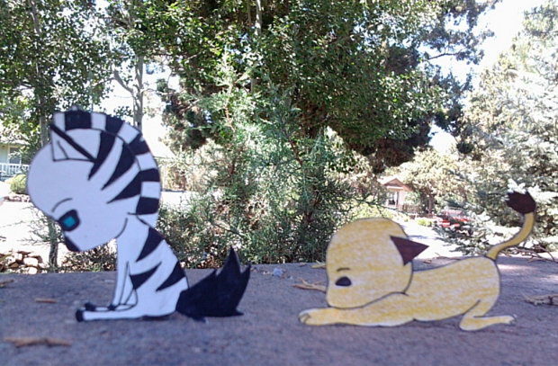 Lion Cub stalking Zebra PaperChild